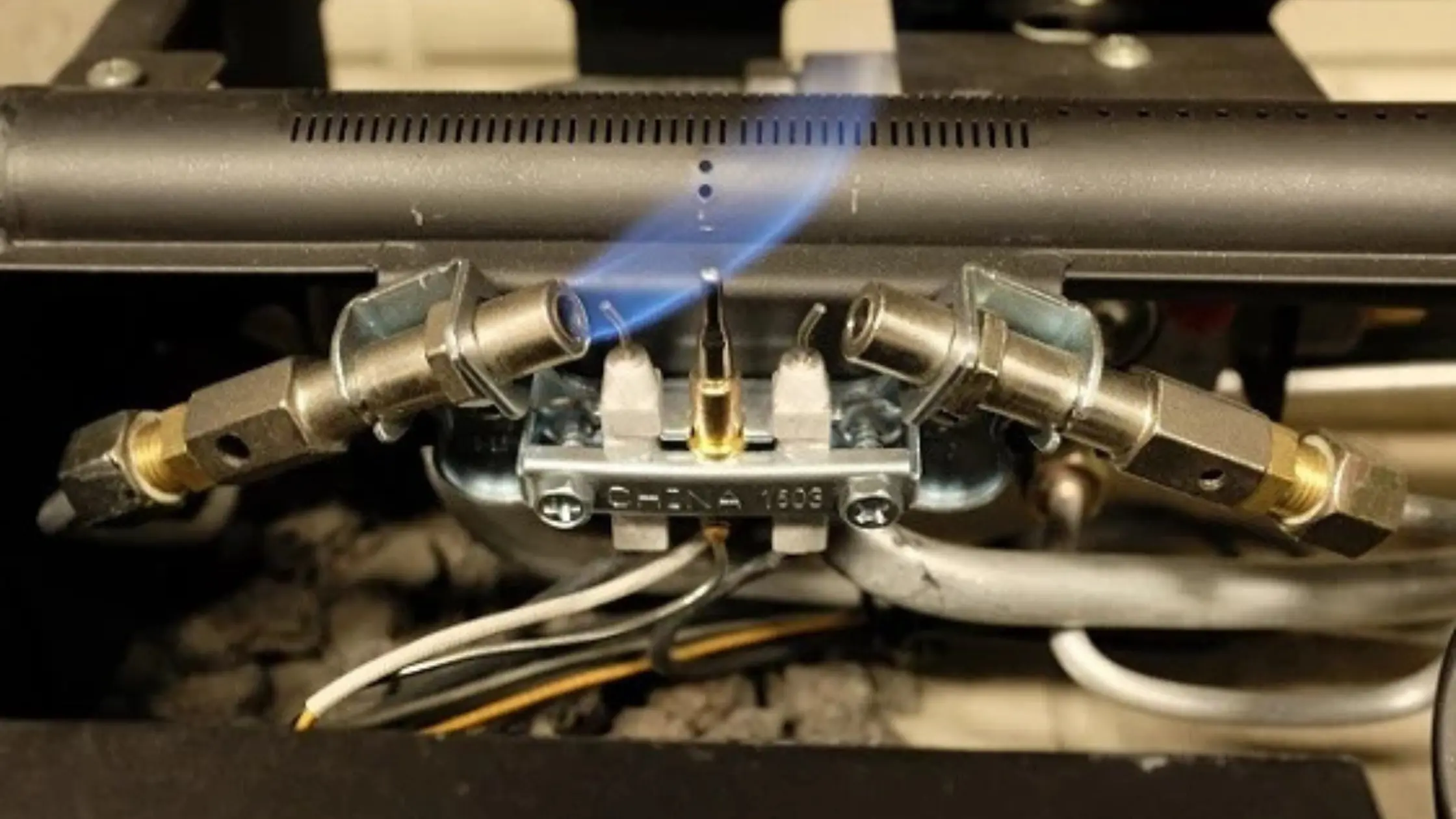 
Close-up of a blue pilot light flame hitting a Dirty Thermocouple in a water heater.